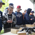 A group of young students interact with an exhibit at Engineering Discovery Days